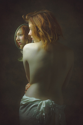 Red Hair. Woman with mirror